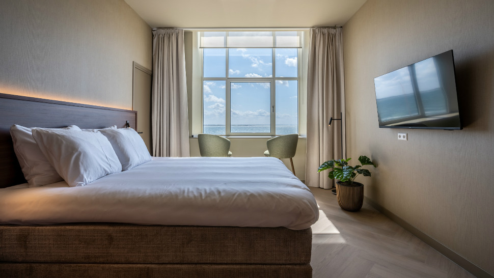 Bedroom overlooking the maritime landscape at Hotel De Zeevaartschool